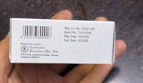 White medicine box held in a hand, showing a barcode, batch TV-010049, Mfg. date 03/2026, Exp. date 02/2029; manufactured in India by Centurion Remedies Pvt. Ltd., Vadodara.