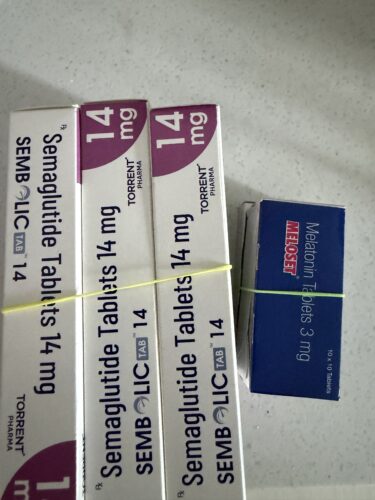 Row of white medicine boxes with purple curved emblem showing '14 mg' and 'Torent Pharma' on the label.