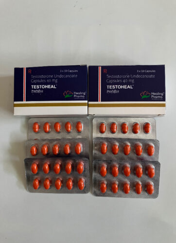 Two dark-blue boxes of TESTOHEAL Testosterone Undecanoate Capsules 40 mg with orange capsules in blister packs laid out below.