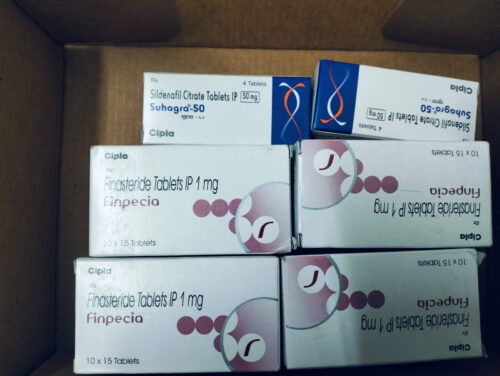Boxes of prescription medication: Finasteride 1 mg (Finpecia) tablets, 10 x 15, in a cardboard box box arrangement with pink circle designs on white packaging