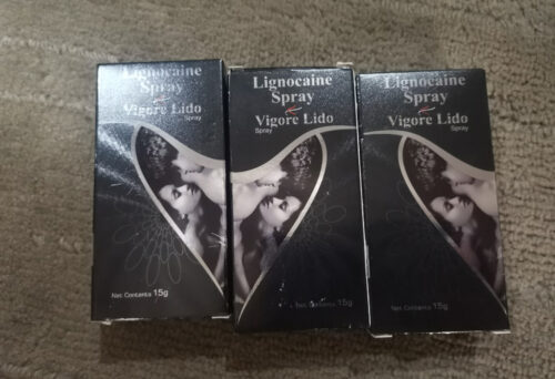 Three black boxes labeled Lignocaine Spray Vigore Lido lined up on a beige carpet.