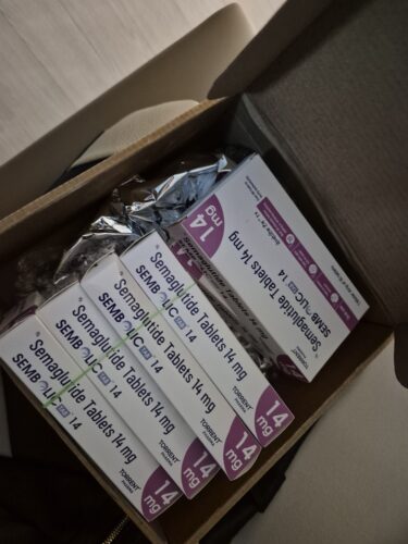 Cardboard box containing multiple Semaglutide 14 mg tablet boxes with purple accents.